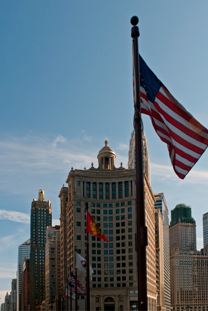 American flag before skyscrapers in Chicago